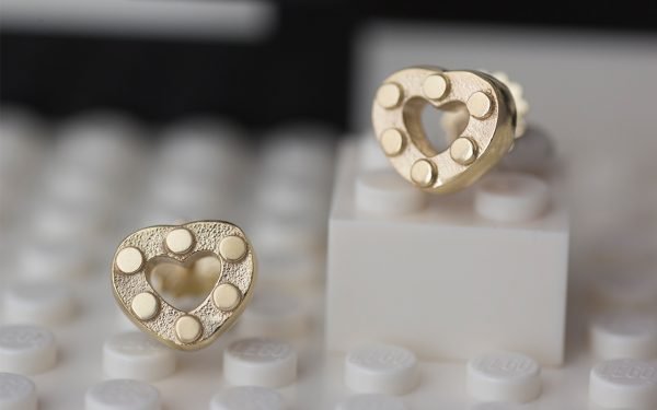 pair of gold heart earrings on lego bricks