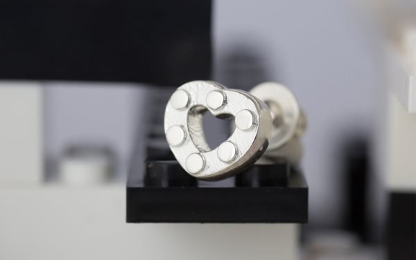 silver earring with lego design