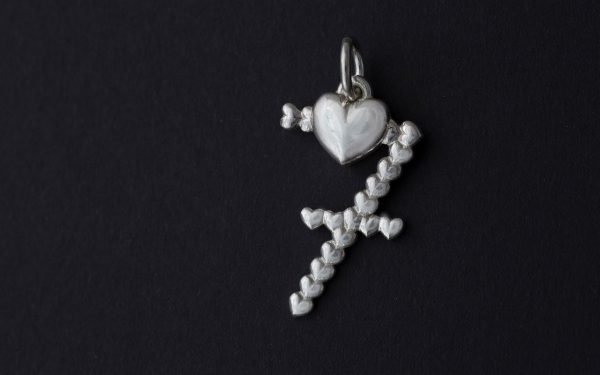 silver lucky number seven pendant on a black background